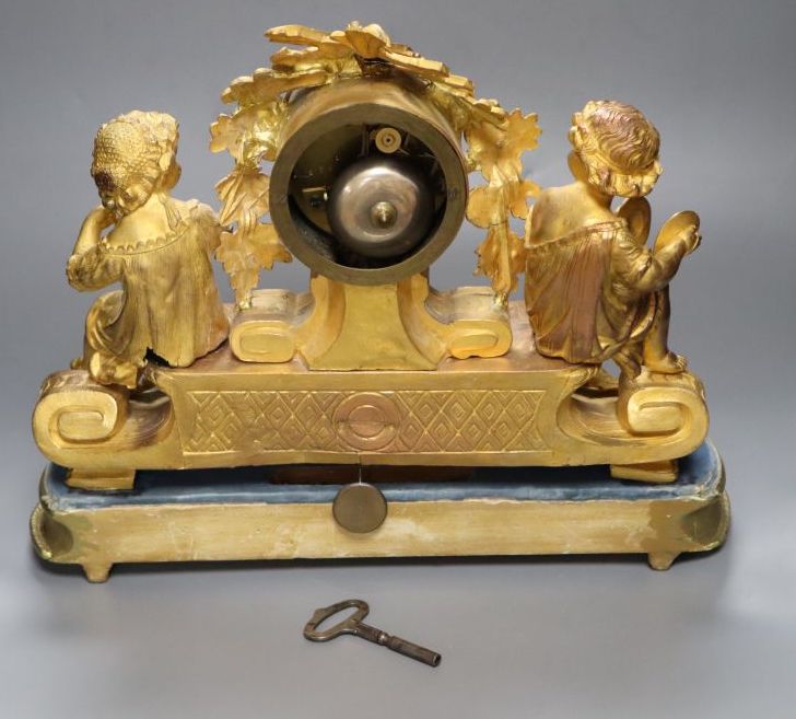 A 19th century French ormolu and gilt metal mantel clock, with musical youth surmount, Vincenti bell striking movement, on giltwood pli